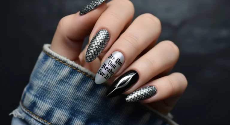 Close-up of almond-shaped nails inspired by Taylor Swift's Reputation album, featuring gunmetal grey snake skin texture, black and silver cat-eye polish, and a nail decal with Gothic text reading "Are You Ready For It?"