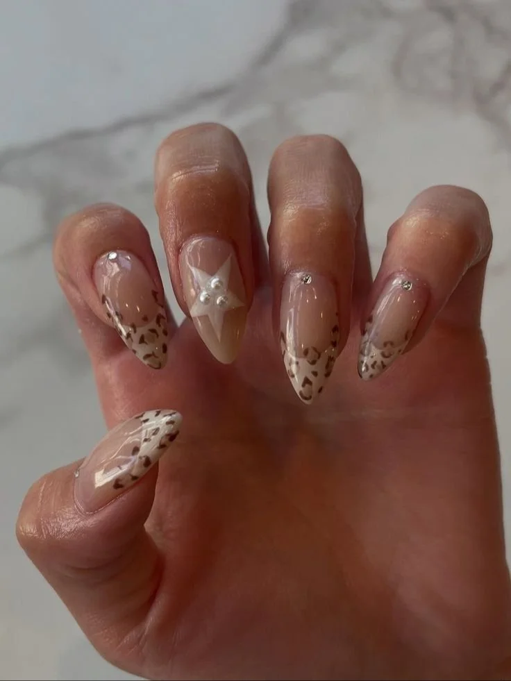 Chic safari inspired vegan nails with neutral tones and pearl star accents from Veness Nail in Vancouver.